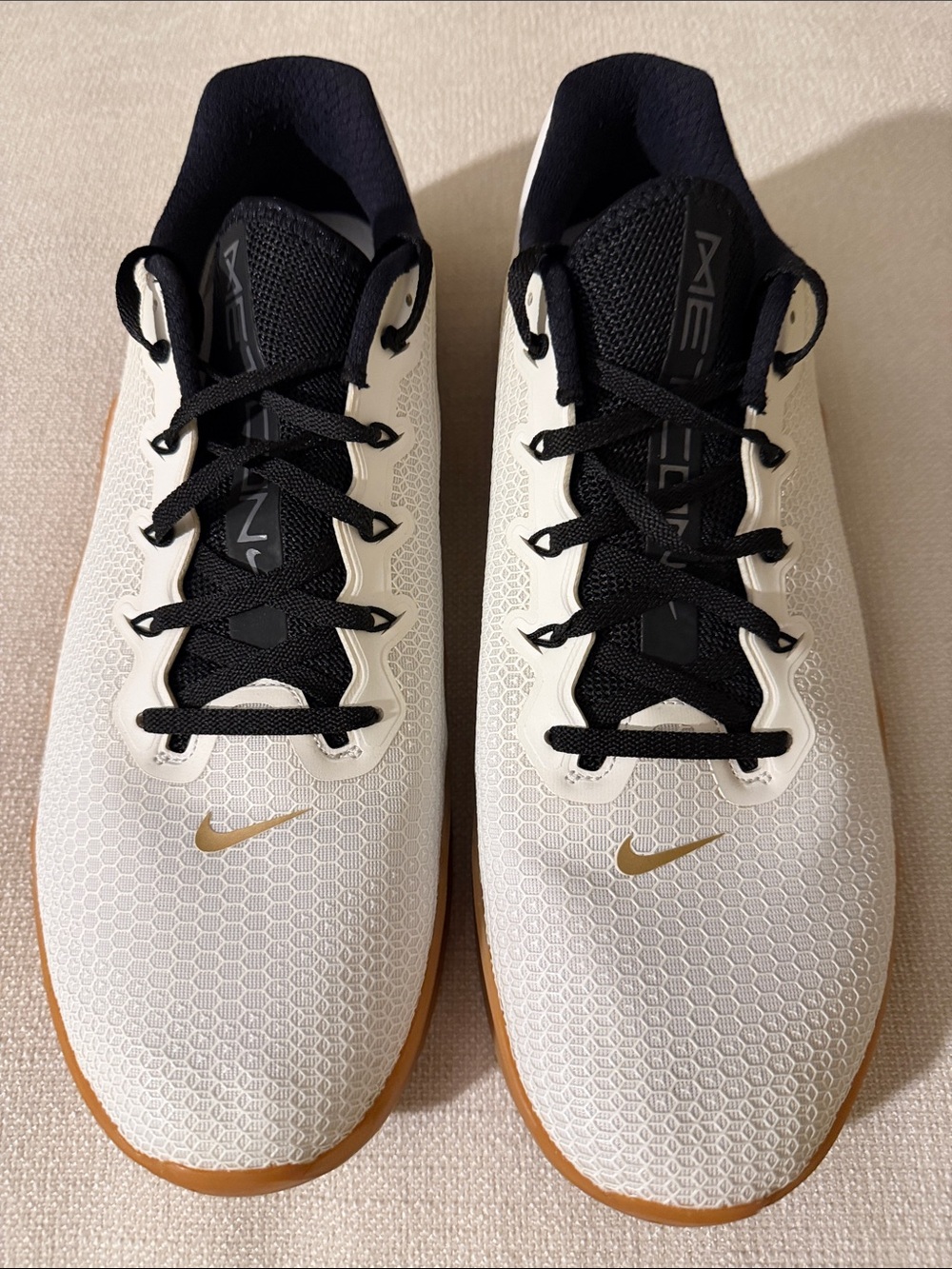 Nike Men’s White and Black Training Sneakers with Gold Swoosh